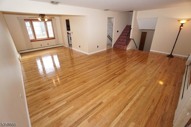 293 Oak Ridge Rd, Clark Twp, NJ 07066 - unfurnished living room featuring a baseboard radiator, stairs, light wood-style flooring, ceiling fan, and baseboards