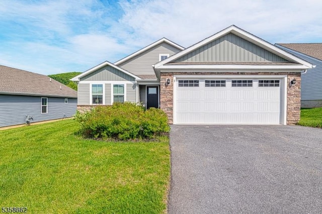 8 Lam Dr, Hardyston Twp, NJ 07419 - craftsman-style house featuring a garage, driveway, stone siding, and a front yard