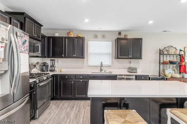 8 Lam Dr, Hardyston Twp, NJ 07419 - kitchen with stainless steel appliances, a sink, a kitchen bar, light countertops, and recessed lighting