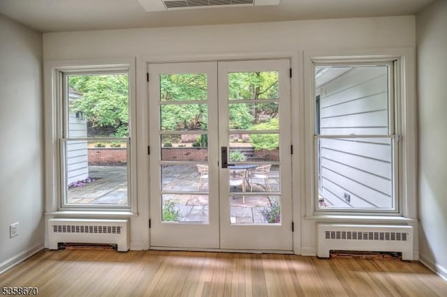 25 Highland Ave, Peapack Gladstone Boro, NJ 07931 - doorway to outside featuring radiator heating unit, wood finished floors, and baseboards