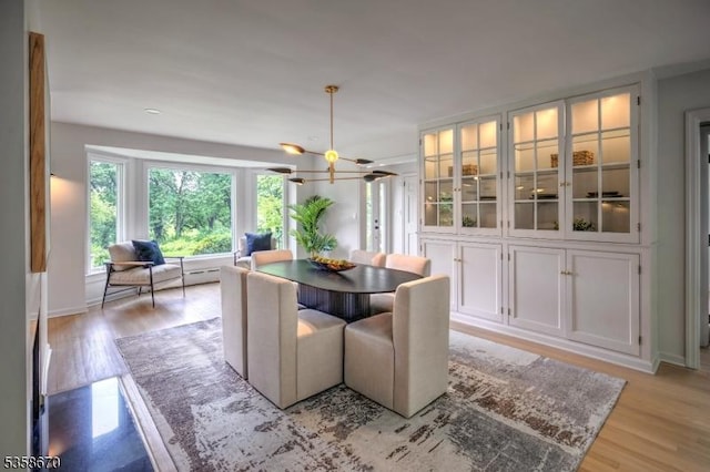 25 Highland Ave, Peapack Gladstone Boro, NJ 07931 - dining space with light wood-style floors, a chandelier, and baseboards