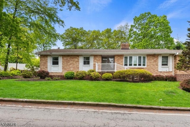 218 Santa Fe Trl, Hopatcong Boro, NJ 07843 - single story home featuring brick siding, a chimney, and a front yard