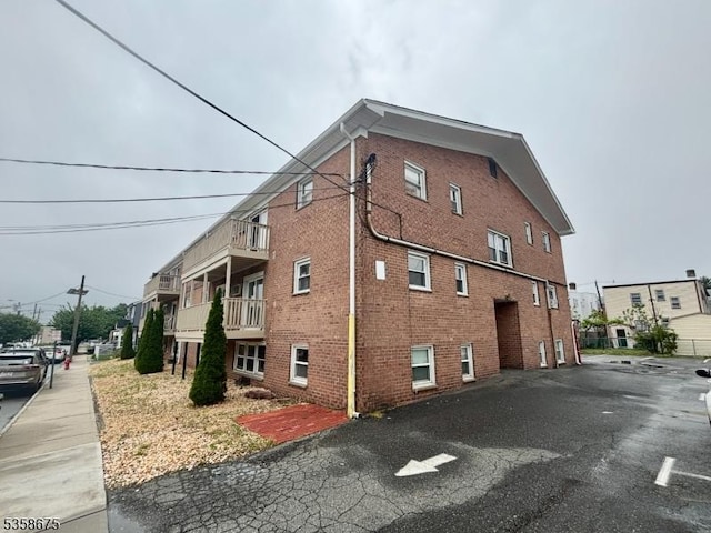 view of side of home featuring brick siding