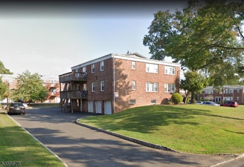 7 Columbia Dr Unit 7, Bridgewater Twp, NJ 08807 - view of building exterior featuring a garage and asphalt driveway