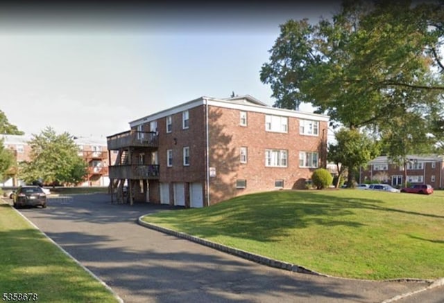 7 Columbia Dr Unit 7, Bridgewater Twp, NJ 08807 - view of building exterior featuring a garage and asphalt driveway