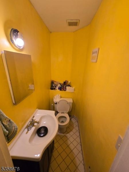 7 Columbia Dr Unit 7, Bridgewater Twp, NJ 08807 - half bath featuring toilet, tile patterned floors, and a sink
