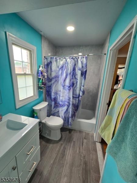 7 Columbia Dr Unit 7, Bridgewater Twp, NJ 08807 - bathroom featuring shower / bathtub combination with curtain, wood finished floors, toilet, and vanity