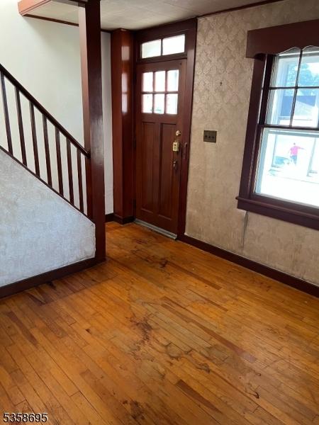 626 Tremont Ave, City Of Orange Twp, NJ 07050 - foyer entrance with wood-type flooring, plenty of natural light, and baseboards