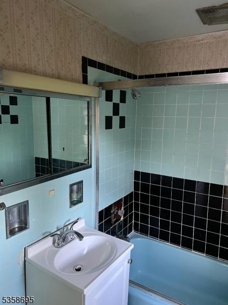 626 Tremont Ave, City Of Orange Twp, NJ 07050 - full bath with vanity,  shower combination, tile walls, and wallpapered walls
