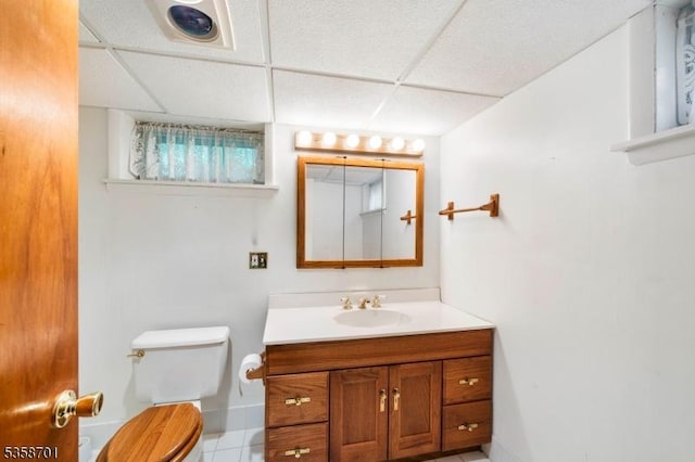 72 Brookside Dr, New Providence Boro, NJ 07974 - bathroom featuring a paneled ceiling, toilet, vanity, tile patterned flooring, and baseboards
