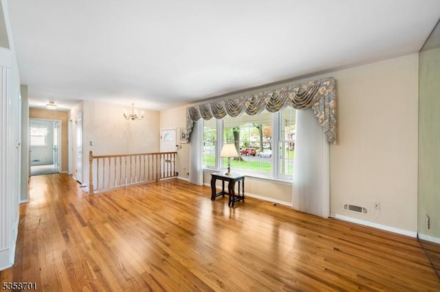 72 Brookside Dr, New Providence Boro, NJ 07974 - unfurnished room with a chandelier, wood finished floors, and baseboards