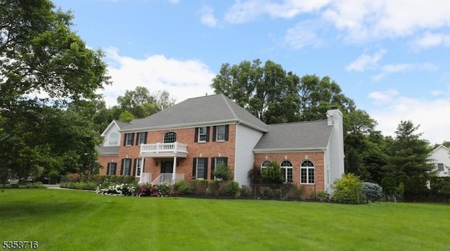 236 Berkley Ave, Montgomery Twp, NJ 08502 - colonial-style house featuring brick siding, a front yard, a chimney, and a balcony