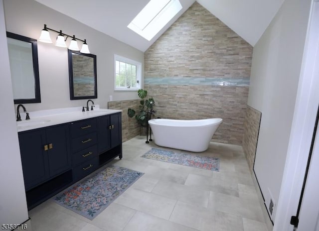 236 Berkley Ave, Montgomery Twp, NJ 08502 - full bathroom featuring a skylight, lofted ceiling, double vanity, a freestanding tub, and tile walls