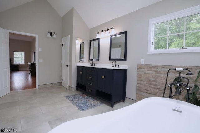 236 Berkley Ave, Montgomery Twp, NJ 08502 - bathroom featuring a freestanding tub, double vanity, and high vaulted ceiling