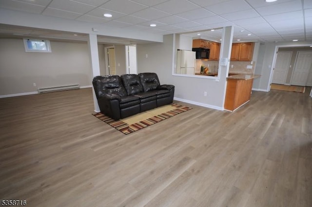 236 Berkley Ave, Montgomery Twp, NJ 08502 - living room featuring baseboard heating, a paneled ceiling, baseboards, and wood finished floors