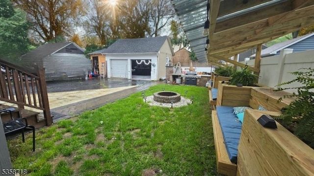 131-133 Sumner Ave, Plainfield City, NJ 07062 - view of yard featuring a fire pit, an outdoor structure, and a detached garage