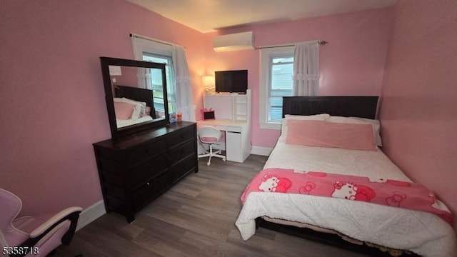 131-133 Sumner Ave, Plainfield City, NJ 07062 - bedroom with a wall unit AC, wood finished floors, baseboards, and an office area