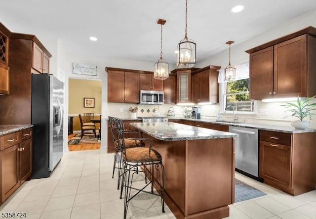 9 Blue Bird Ct, Randolph Twp, NJ 07869 - kitchen featuring appliances with stainless steel finishes, recessed lighting, a sink, a kitchen breakfast bar, and dark stone counters