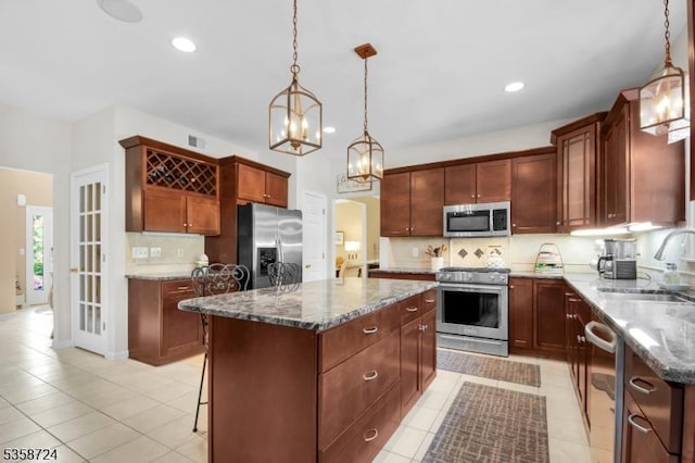 9 Blue Bird Ct, Randolph Twp, NJ 07869 - kitchen with appliances with stainless steel finishes, a sink, a center island, dark stone countertops, and tasteful backsplash