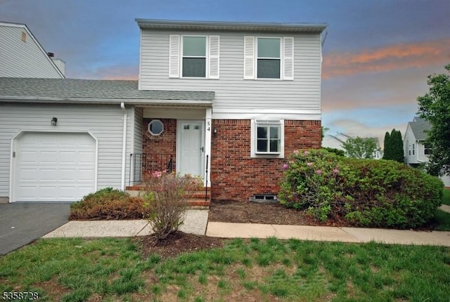 view of front of house featuring a garage, brick siding, and driveway
