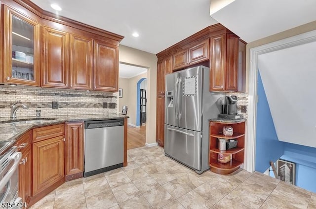 206 Thomas St, Cranford Twp, NJ 07016 - kitchen featuring appliances with stainless steel finishes, a sink, backsplash, glass insert cabinets, and stone countertops