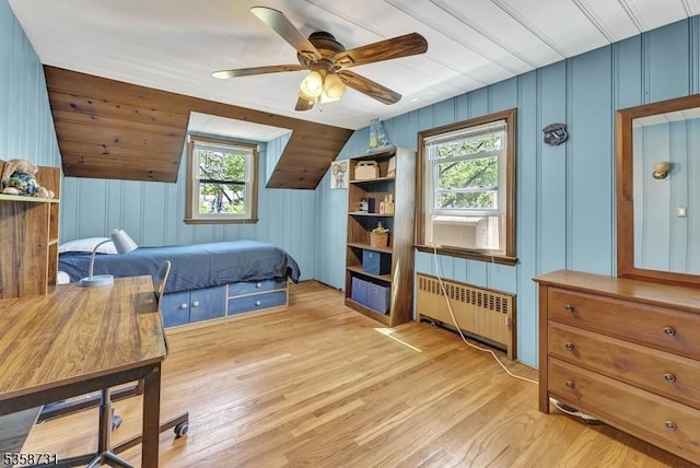 206 Thomas St, Cranford Twp, NJ 07016 - bedroom featuring radiator heating unit, multiple windows, light wood-style floors, a ceiling fan, and a decorative wall