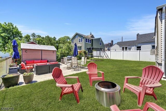 206 Thomas St, Cranford Twp, NJ 07016 - view of yard featuring an outdoor living space with a fire pit, a patio area, and a trampoline
