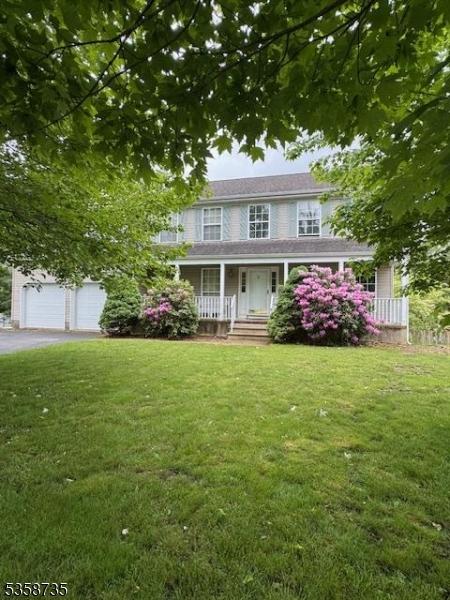 143 Crenshaw Dr, Mount Olive Twp, NJ 07836 - view of front of house featuring a porch, a garage, and a front lawn