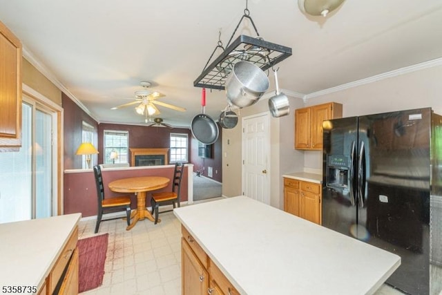 143 Crenshaw Dr, Mount Olive Twp, NJ 07836 - kitchen with black fridge with ice dispenser, a ceiling fan, light countertops, crown molding, and a fireplace