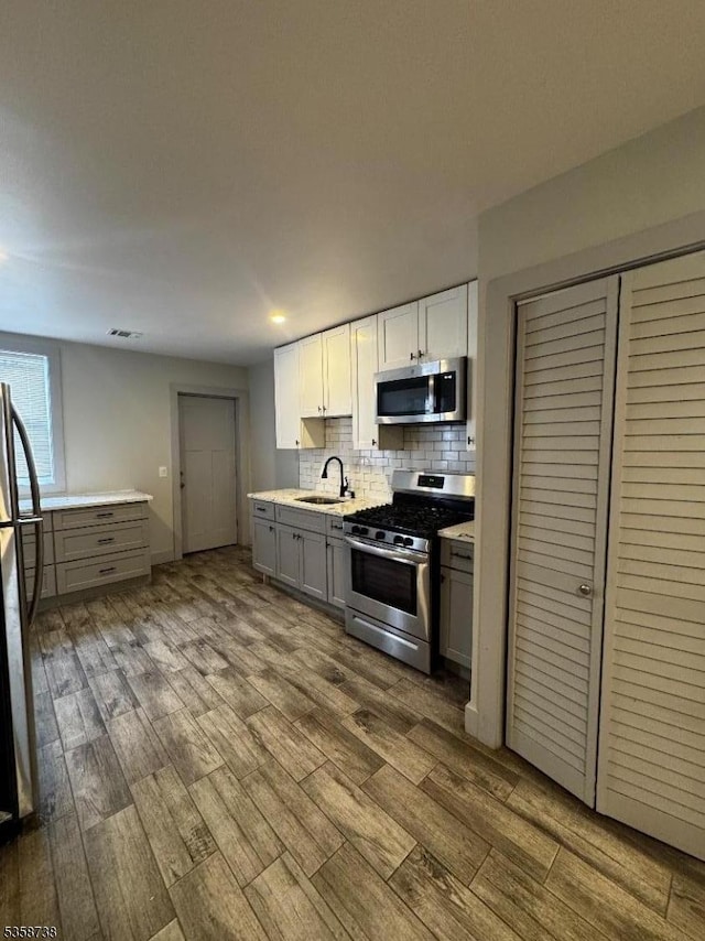 53 2nd Ave, Newark City, NJ 07104 - kitchen with stainless steel appliances, a sink, dark wood-type flooring, and gray cabinets