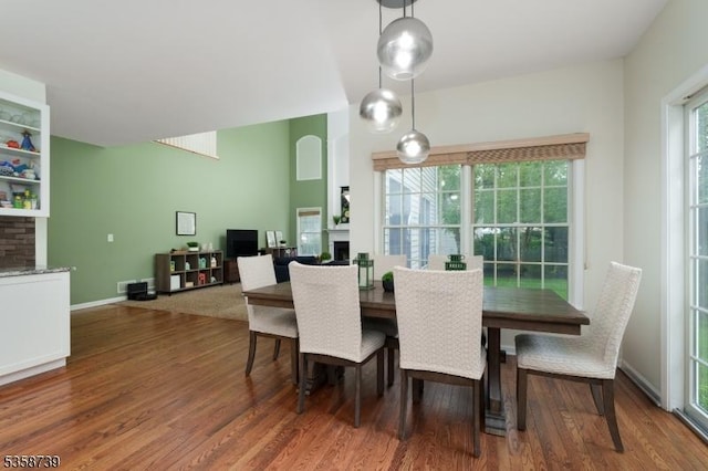 3 Firestone Ct, Montgomery Twp, NJ 08558 - dining area with a fireplace, wood finished floors, and baseboards