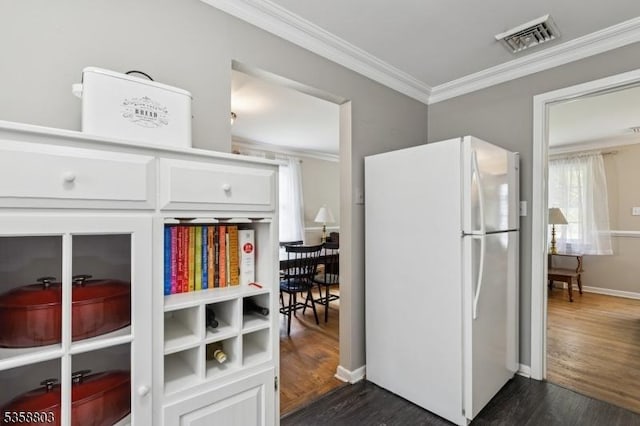 457 Valley Rd, Long Hill Twp, NJ 07933 - kitchen featuring freestanding refrigerator, ornamental molding, dark wood-style flooring, and white cabinets