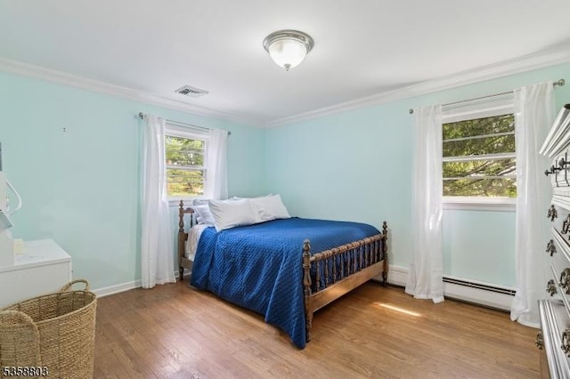 457 Valley Rd, Long Hill Twp, NJ 07933 - bedroom featuring a baseboard radiator, ornamental molding, and light wood-style flooring