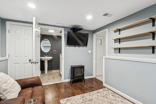 457 Valley Rd, Long Hill Twp, NJ 07933 - living room featuring a wood stove, wood finished floors, and recessed lighting