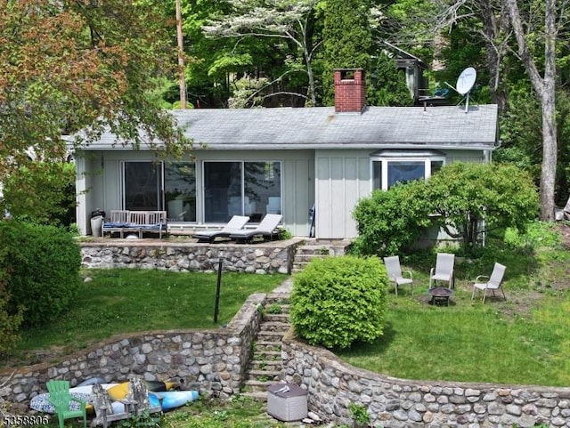110 Lower N Shore Rd, Frankford Twp, NJ 07826 - rear view of property featuring board and batten siding, a chimney, a lawn, and stairway