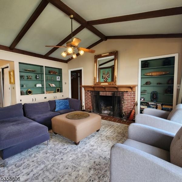 110 Lower N Shore Rd, Frankford Twp, NJ 07826 - living room featuring a ceiling fan, a fireplace, and built in shelves