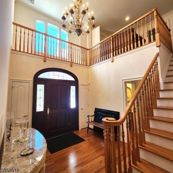 15 Hemlock Ave, Frankford Twp, NJ 07826 - foyer featuring a high ceiling, stairway, a chandelier, healthy amount of natural light, and wood finished floors