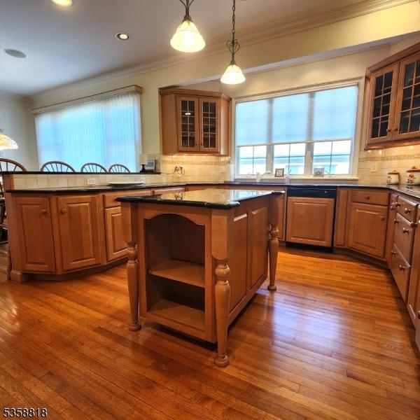 15 Hemlock Ave, Frankford Twp, NJ 07826 - kitchen with a center island, ornamental molding, backsplash, decorative light fixtures, and hardwood / wood-style flooring