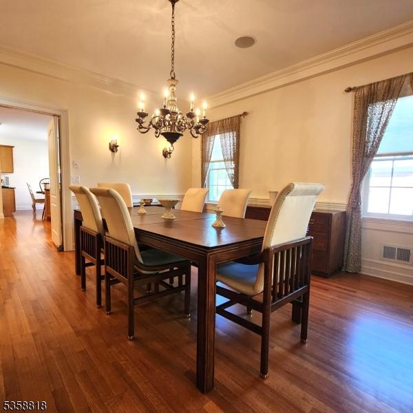 15 Hemlock Ave, Frankford Twp, NJ 07826 - dining area featuring healthy amount of natural light, crown molding, a chandelier, and wood finished floors