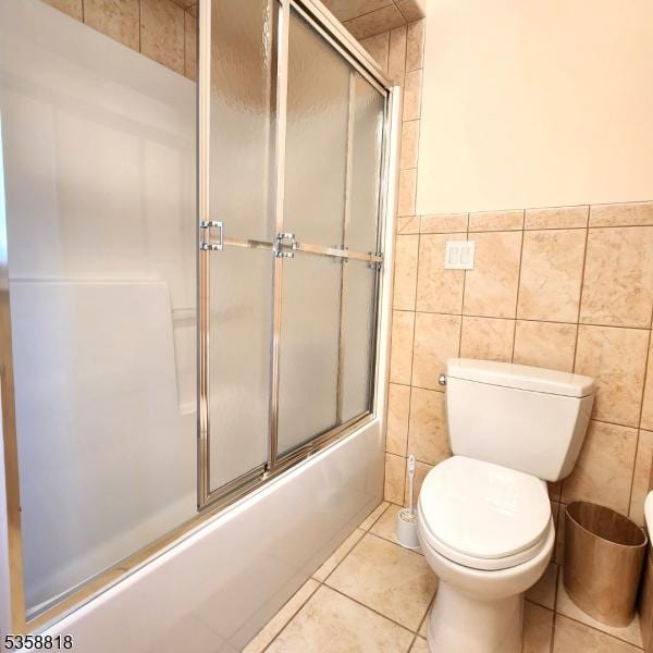 15 Hemlock Ave, Frankford Twp, NJ 07826 - full bathroom featuring tile patterned flooring, tile walls, toilet, enclosed tub / shower combo, and a wainscoted wall
