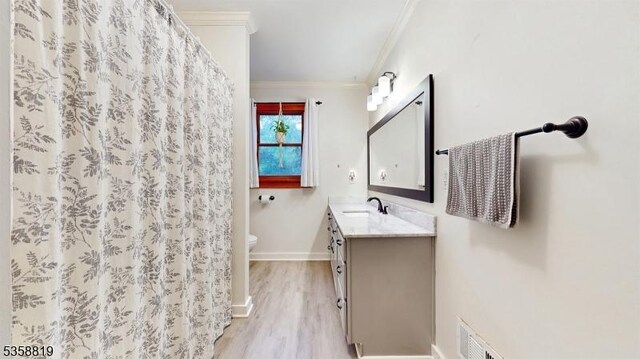 6 County Road 579, East Amwell Twp, NJ 08551 - bathroom with ornamental molding, toilet, vanity, wood finished floors, and baseboards