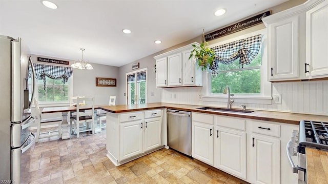 6 County Road 579, East Amwell Twp, NJ 08551 - kitchen with appliances with stainless steel finishes, wooden counters, a sink, a chandelier, and a peninsula