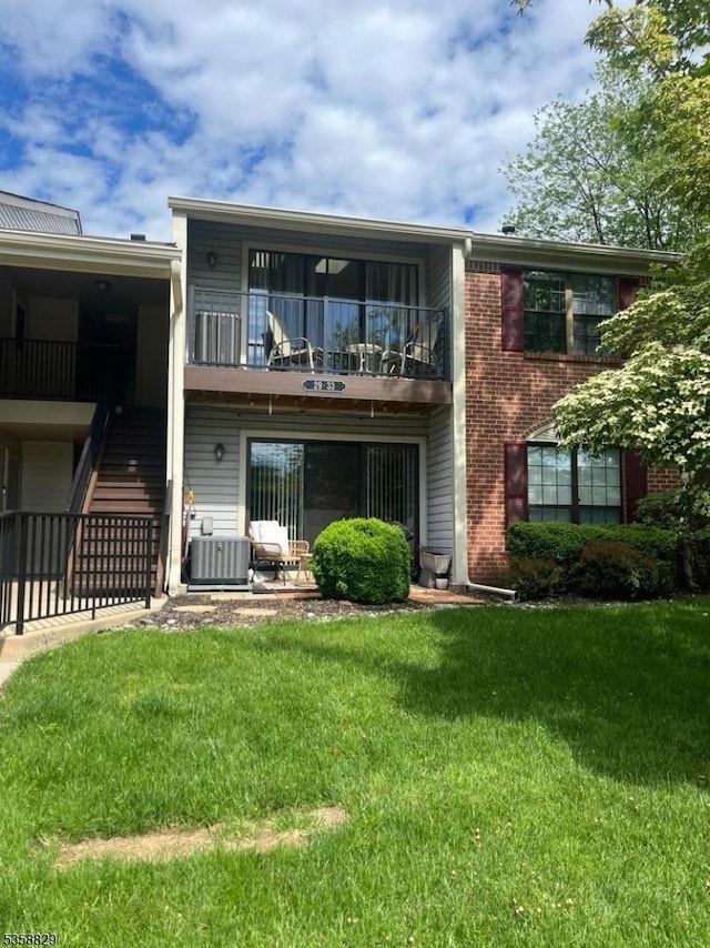 31 Baldwin Ct, Condo, Bernards Twp, NJ 07920 - rear view of house with a balcony, a lawn, central AC, brick siding, and stairs