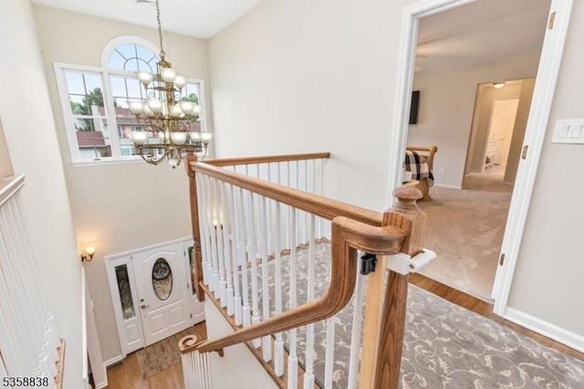 411 Arlington Ave, South Plainfield Boro, NJ 07080 - stairway with a chandelier, wood finished floors, and baseboards