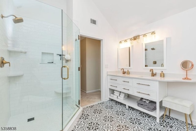 411 Arlington Ave, South Plainfield Boro, NJ 07080 - bathroom with lofted ceiling, a shower stall, double vanity, baseboards, and tile patterned floors
