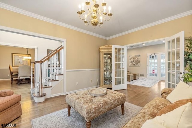 411 Arlington Ave, South Plainfield Boro, NJ 07080 - living area featuring french doors, wood finished floors, a chandelier, stairway, and ornamental molding