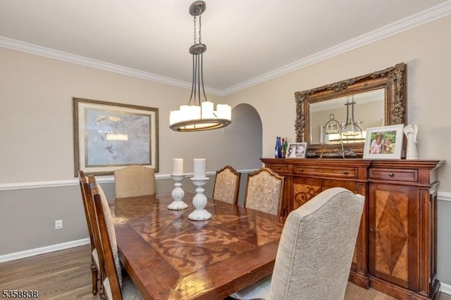 411 Arlington Ave, South Plainfield Boro, NJ 07080 - dining area featuring crown molding, wood finished floors, arched walkways, a chandelier, and baseboards