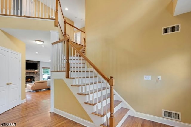 1364 Springfield Ave, New Providence Boro, NJ 07974 - stairs with a fireplace, wood finished floors, and a high ceiling