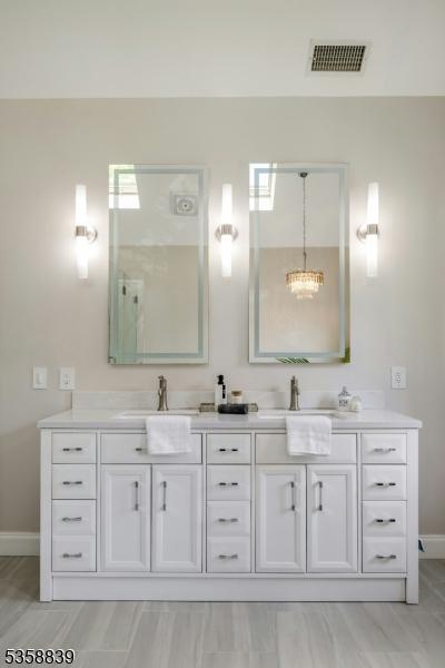 1364 Springfield Ave, New Providence Boro, NJ 07974 - bathroom with double vanity and a chandelier