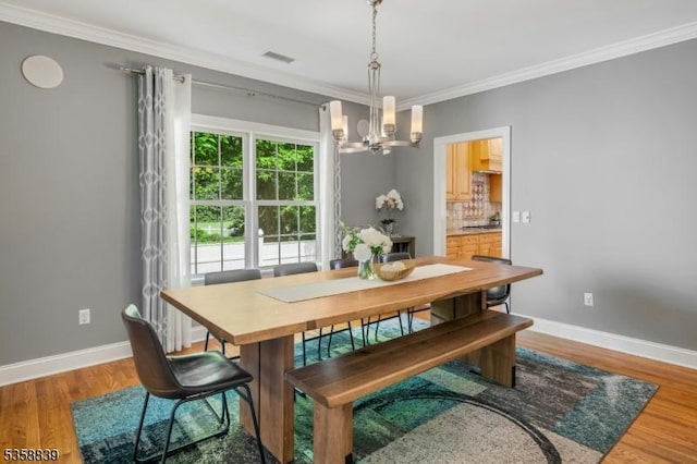 1364 Springfield Ave, New Providence Boro, NJ 07974 - dining space featuring a chandelier, crown molding, and wood finished floors